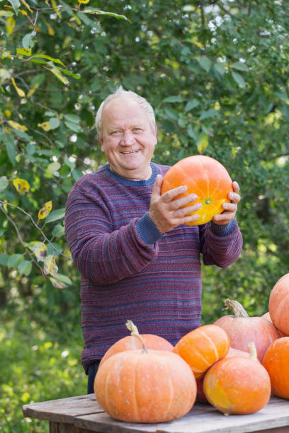 istock elderly men with pumpinks outdoor 1141841842