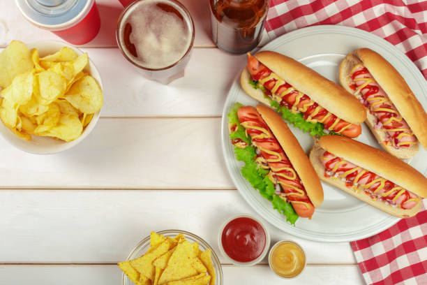 istock Hot dogs on wooden background 1141842385