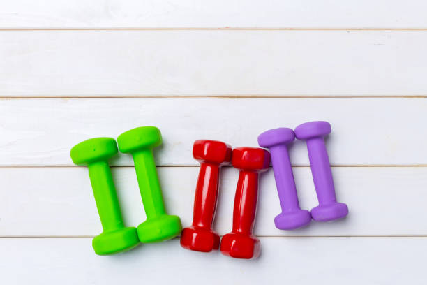 istock dumbells on wooden floor 1141848033