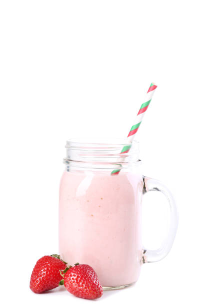 istock Strawberry smoothie in glass jar with straw on white background 1141852211