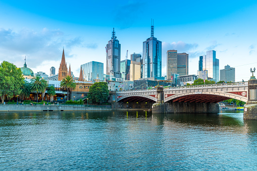 Sunset view of Yarra River and skyline of Melbourne, Victoria, Australia\n\nReflection of lights and office buildings in the water