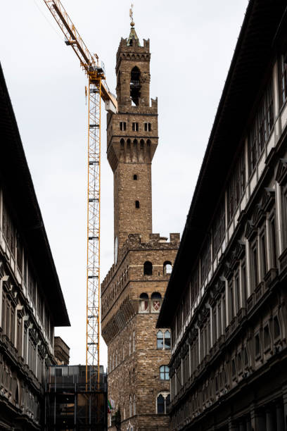 istock Old famous bell tower landmark with construction restoring tower in Firenze, Italy 1141855228