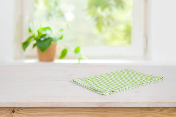 istock Kitchen rustic background with empty wooden table and green napkin 1141864539