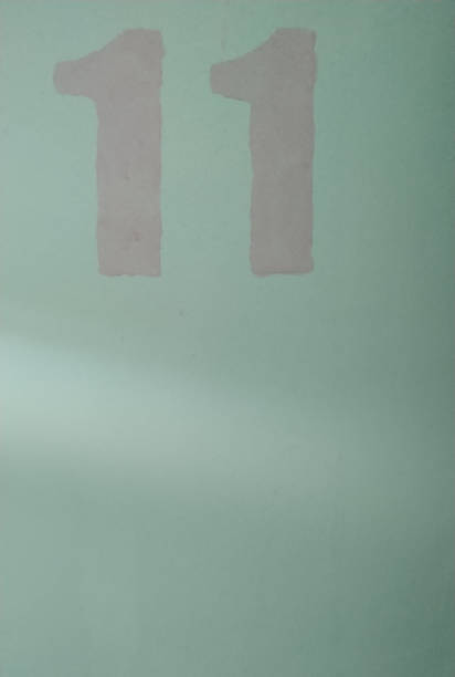 istock Figure 11 painted in purple on a blue background. Close-up. 1141865043