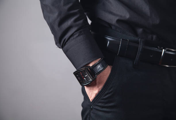 istock Hand in pocket with wrist watch. 1141866400