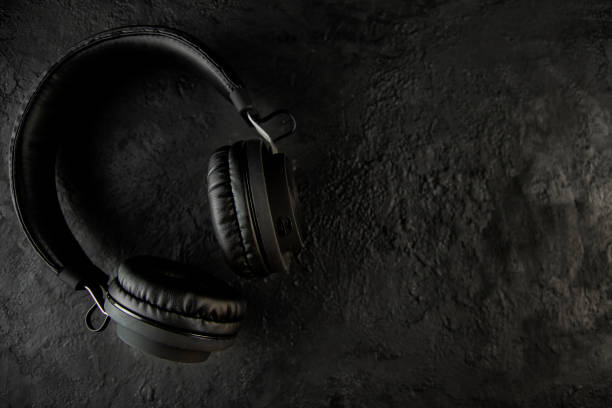 istock Headphones on a black stone background 1141867751