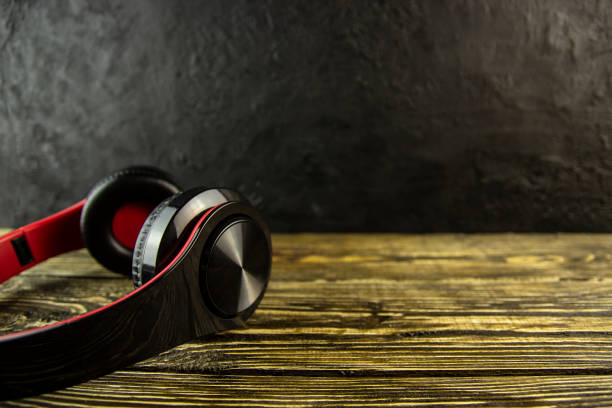 istock Headphones on wooden background 1141867794