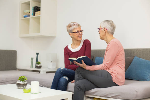 istock Mother and daughter reading a book 1141868016