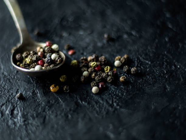istock Spoon with allspice on a dark stone background 1141869069