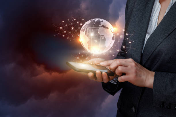 istock A businesswoman is operating with global networking system on her gadget. 1141869534