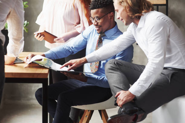 istock Looking at graphic illustration. Office workers having conversation during their job 1141869694