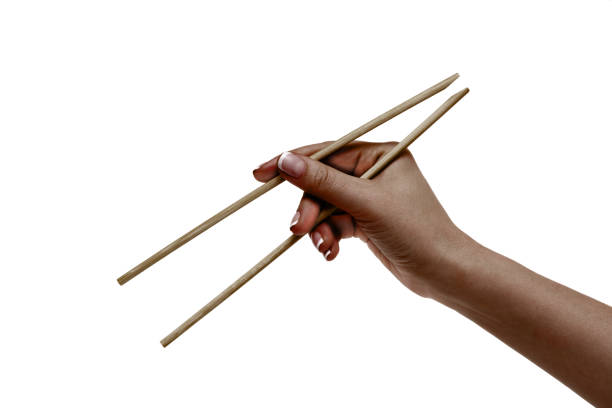 African female hand holds chopsticks on a white background.