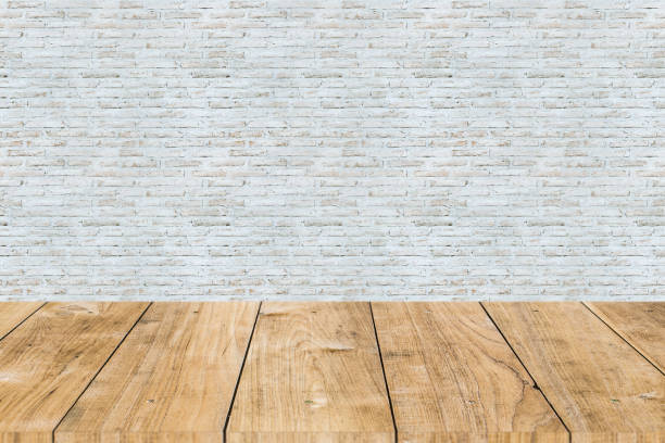 istock white paint brick wall with wooden table forground 1141874231