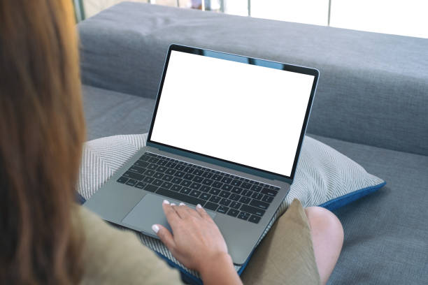 istock a woman using and touching on laptop touchpad with blank white screen while sitting in living room 1141877346