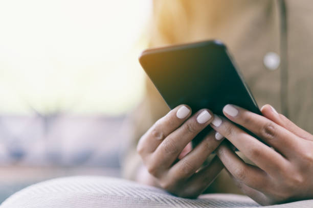 istock a woman's hands holding and using mobile phone 1141877386