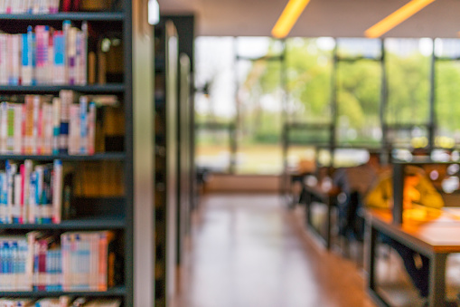 Blurry room with bookshelves by defocused effect. use for background or backdrop in business or education concepts.