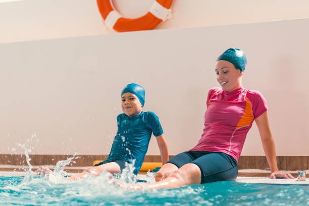 istock Boy Learning To Swim In Pool With Teacher 1141880050
