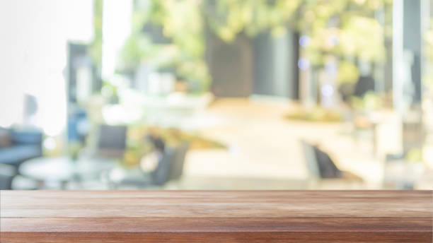 istock Empty wood table top and blurred bokeh cafe and restaurent interior background with vintage filter - can used for display or montage your products. 1141880118
