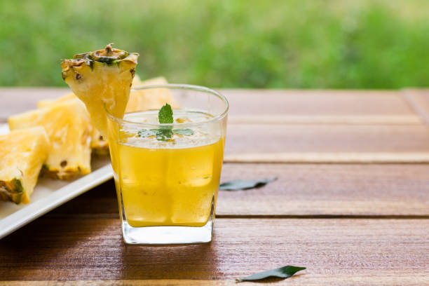 istock Pineapple fruits drink on wooden background. 1141882187