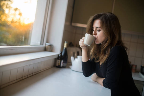 istock Young woman drinking coffee 1141884635