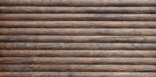 Wooden wall assembled of beams or logs This is an old wooden wall assembled of beams or logs. gnarly wood texture stock pictures, royalty-free photos & images