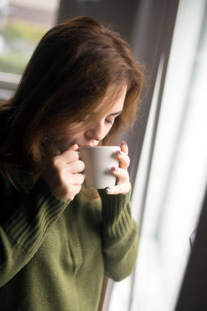istock Young woman drinking coffee 1141885863