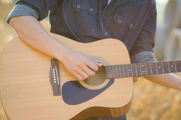 istock Playing on acoustic guitar outdoor 1141886044