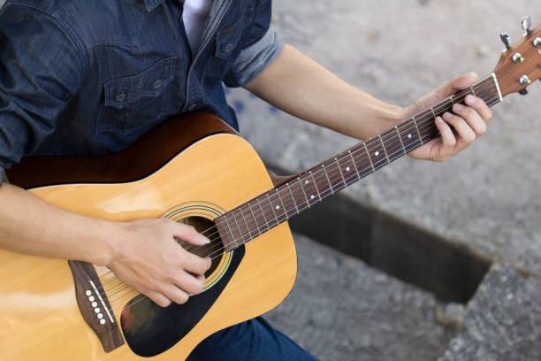 istock Playing on acoustic guitar outdoor 1141886139