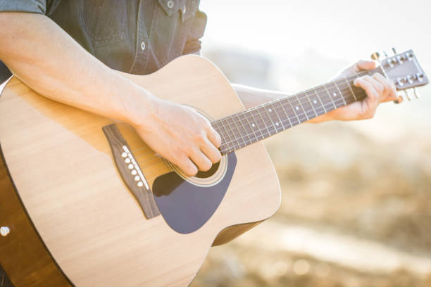 istock Playing on acoustic guitar outdoor 1141886165