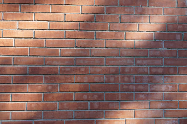 istock Background of ordinary red brick wall. City background 1141886246