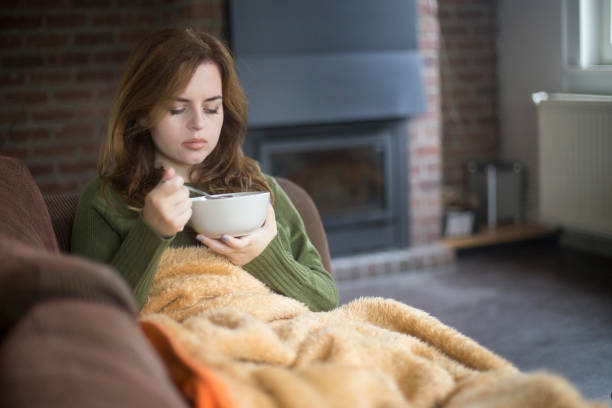 istock Sick woman eating soup 1141886304
