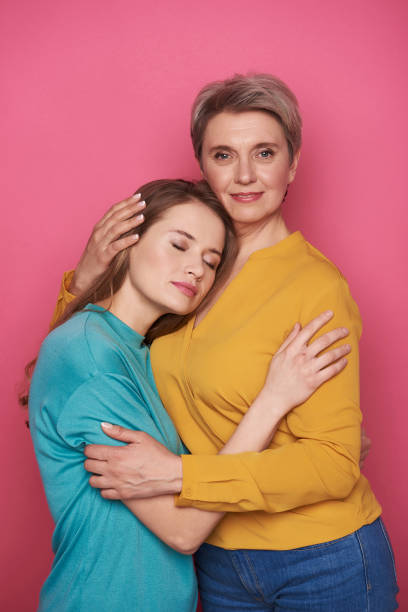 istock Beautiful Caucasian woman is pitying her daughter while looking at camera 1141886830