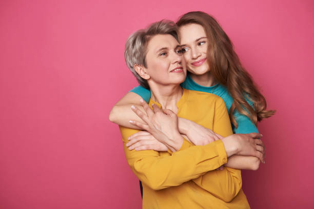 istock Beautiful woman with her charming daughter posing for camera 1141886843