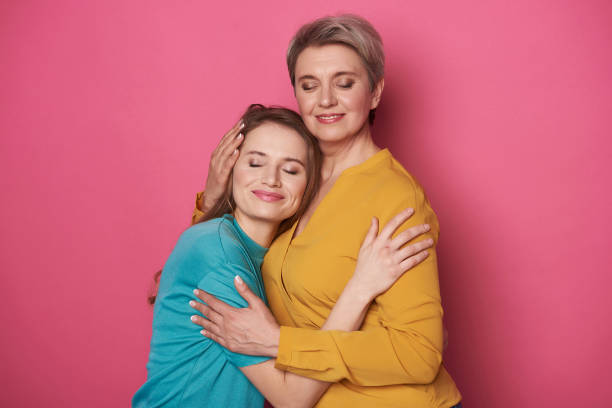 istock Beautiful Caucasian woman is pitying her daughter while posing for camera 1141886869