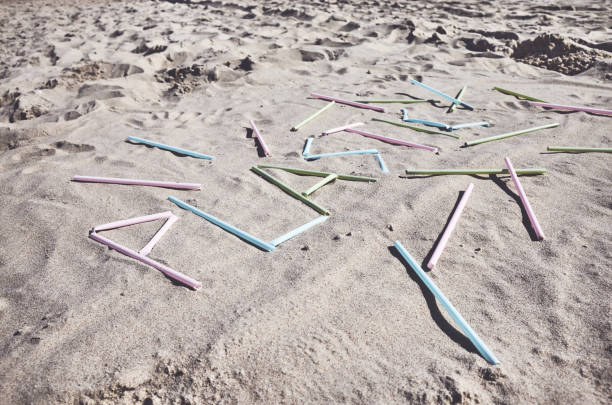 istock Plastic word made of plastic straws on sand. 1141893583