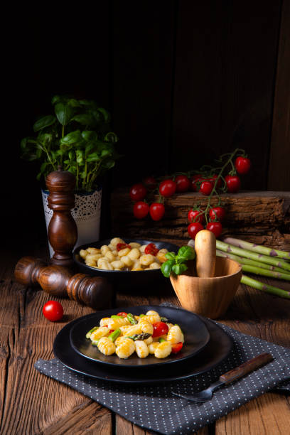 istock crispy gnocchi with roasted asparagus and tomatoes 1141899661