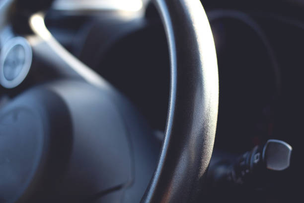 istock Black automobile car steering wheel close up 1141899769