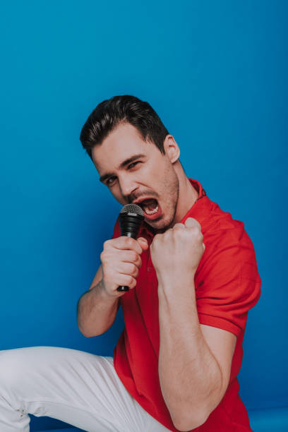 istock Half length of unshaven guy looking at camera with microphone in arm 1141903446