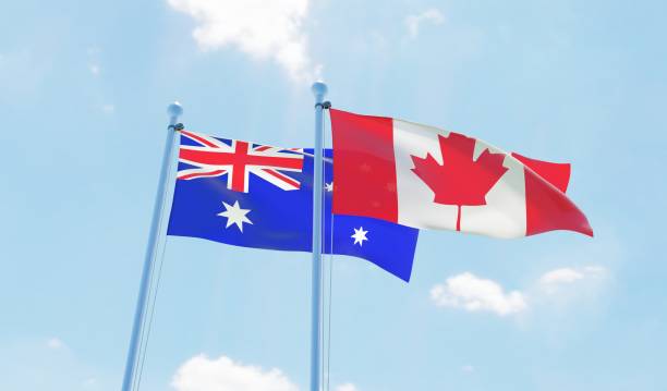 istock Canada and Australia, two flags waving against blue sky 1141904437
