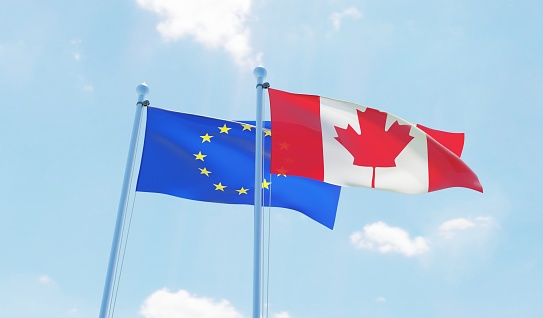 Canada and European Union, two flags waving against blue sky. 3d image