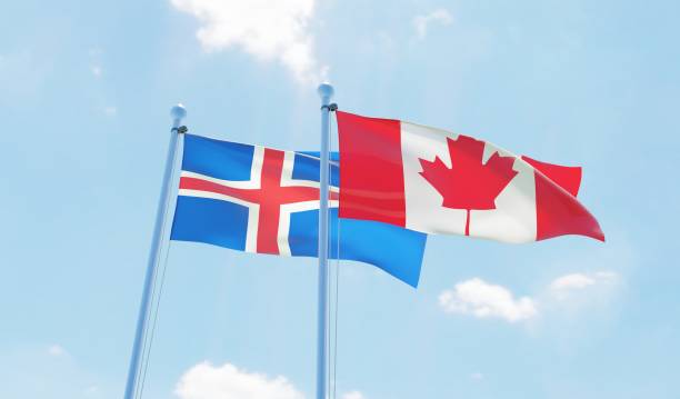 istock Canada and Iceland, two flags waving against blue sky 1141904765