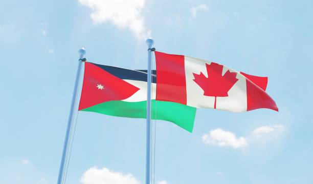 istock Canada and Jordan, two flags waving against blue sky 1141904910