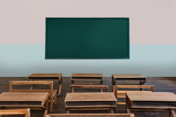 istock Antique classroom in school with Rows of empty wooden desks 1141906621