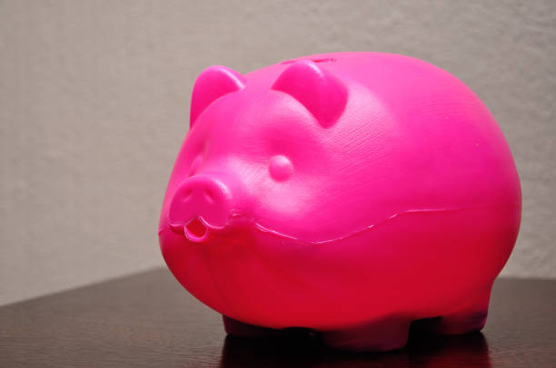 istock A plastic piggy bank on a table 1141907477