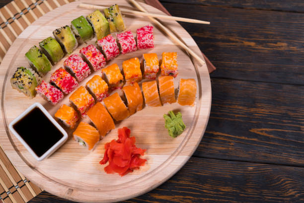 istock Assorted fresh sushi rolls on a wooden board 1141909698