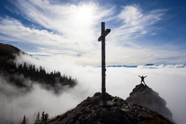 Hiker on top to summit Taubenstein mountain, Bavaria, Germany