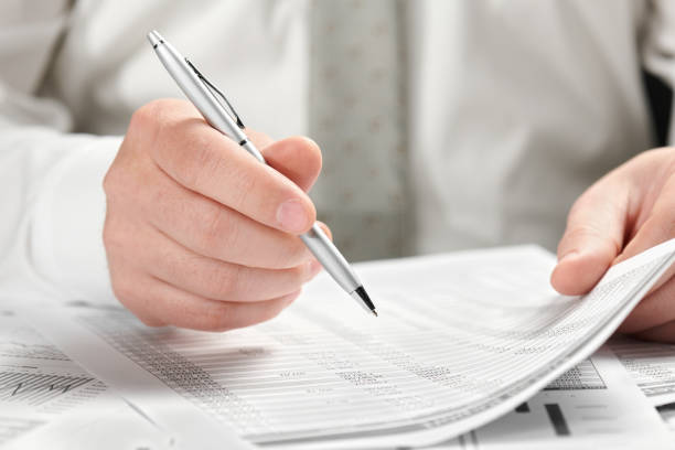 istock Businessman working in an office. Hands and documents closeup. 1141911037