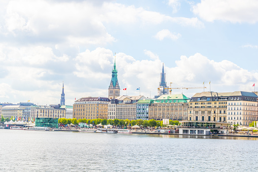 View of the old town in Hamburg behind aussenalster lake, Germany