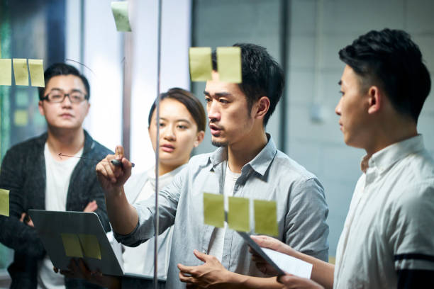 young asian business people meeting in office - chinese ethnicity imagens e fotografias de stock