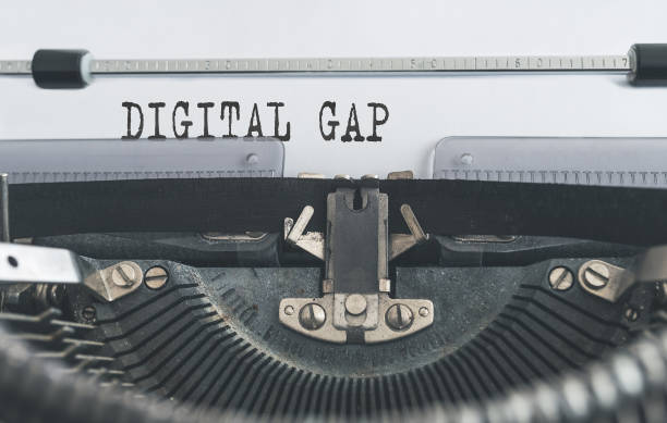 istock words DIGITAL GAP written on old manual typewriter 1141914915